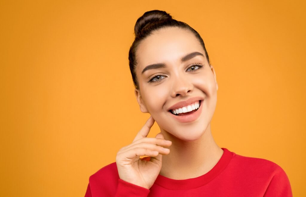 A female patient showing off her non-gummy smile at Matthews Dental Spa.